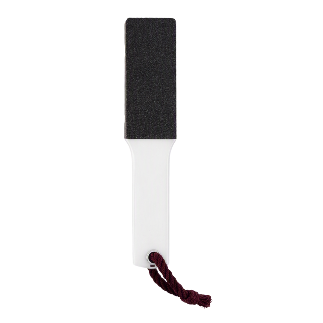 A rectangular black and clear Perspex foot file scrubber with a dark red hanging cord, shown against a plain white background.