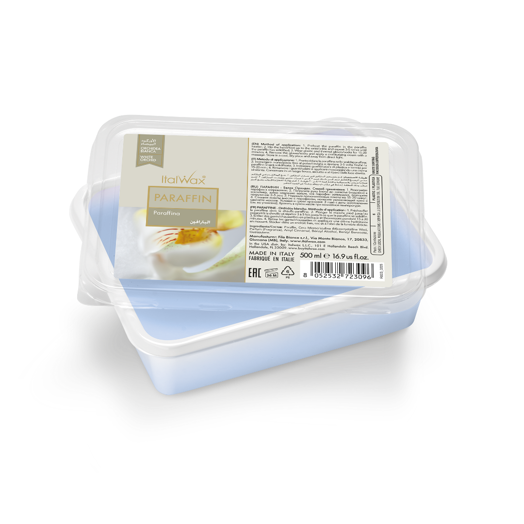 A 500ml plastic tub of Italwax paraffin wax, shown from a top-down angle on a white background. The tub is clear plastic with a light blue interior, featuring a white and gold label with product details and a photo of an orchid